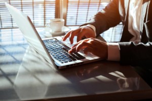 working on laptop, close up of hands of businessman