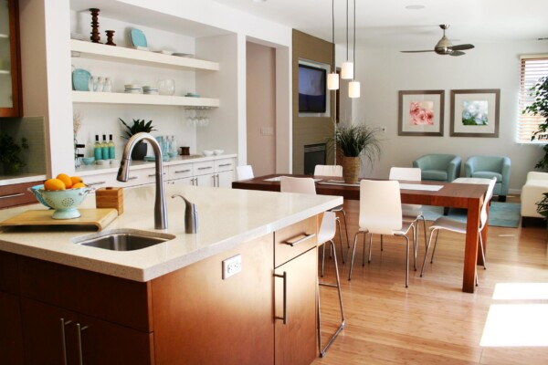 Modern kitchen and dining area with wooden floors.